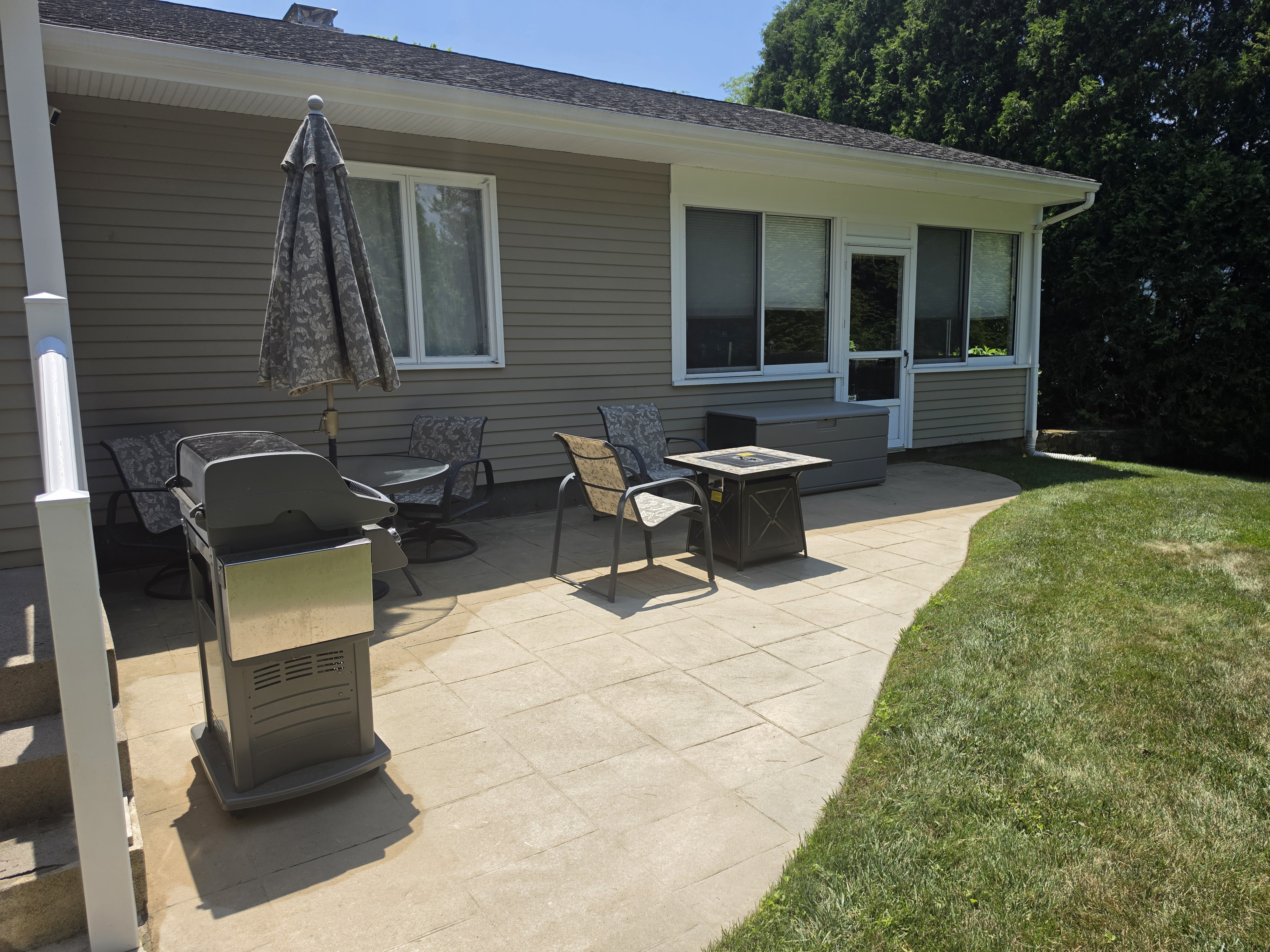 Stone patio with gas grill and fire table