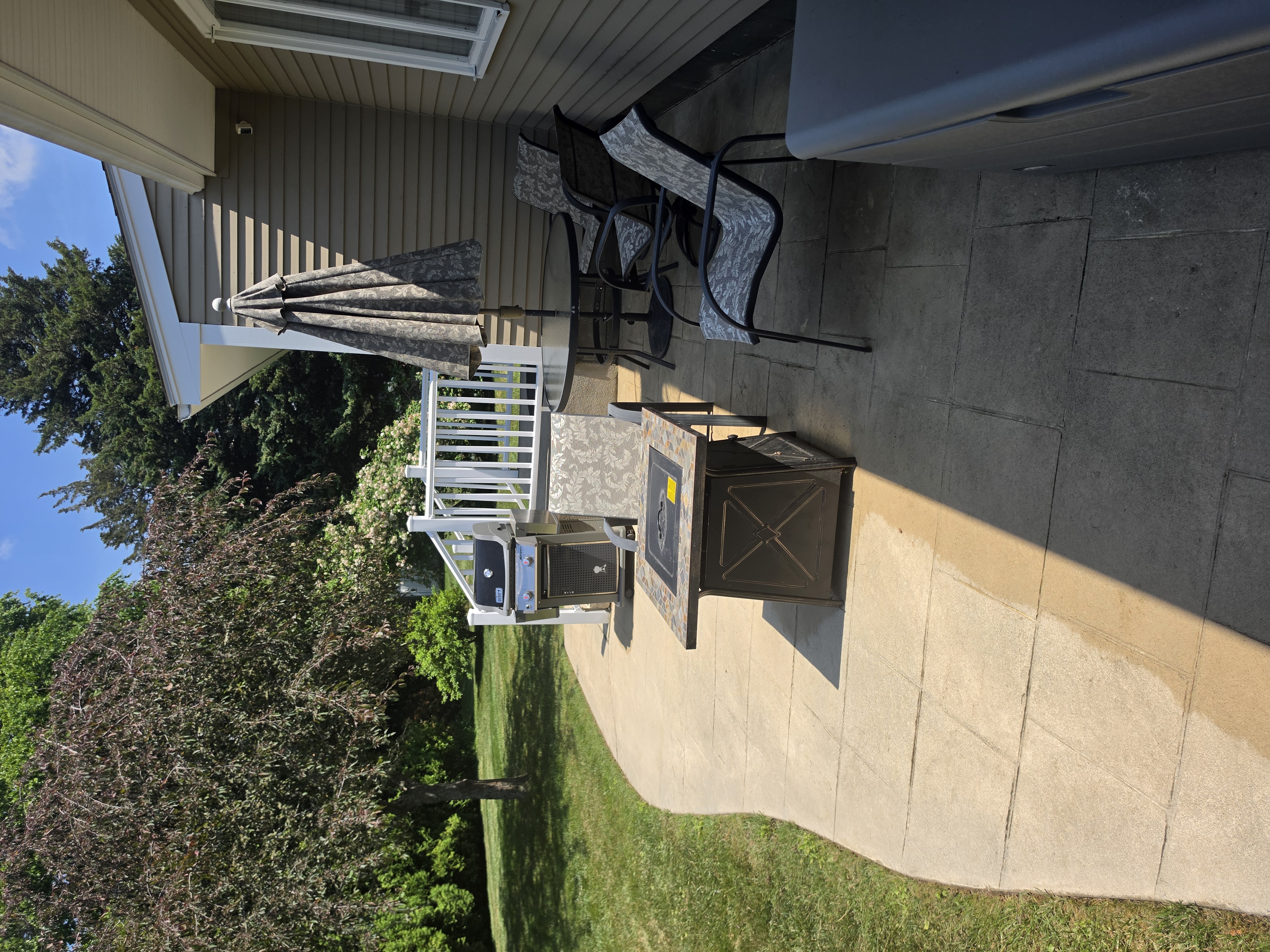 Outdoor seating area with fire table and grill